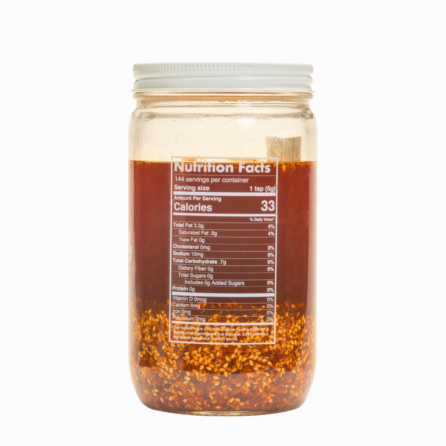 Nutrition facts & clean-label ingredients on a bulk 32oz Ruby Crunch olive oil chili crisp jar, showing the ruby hued oil inside.