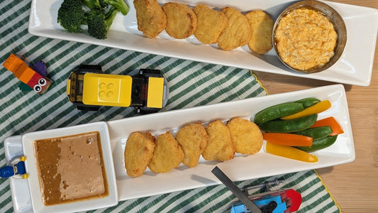 Plates with chicken nuggets, various vegetables and kid friendly dipping sauces made with Ruby Crunch chili crisp