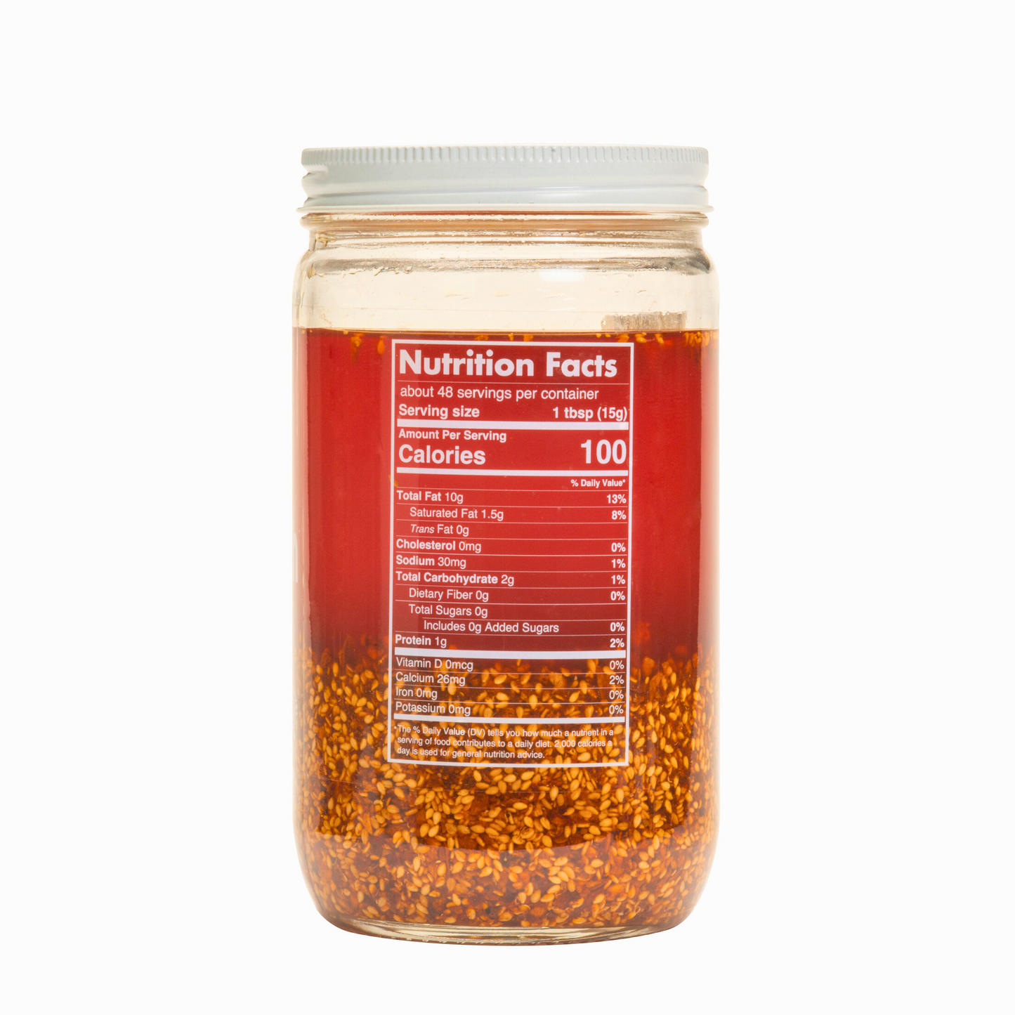 Nutrition facts & clean-label ingredients on a bulk 32oz Ruby Crunch olive oil chili crisp jar, showing the ruby hued oil inside.