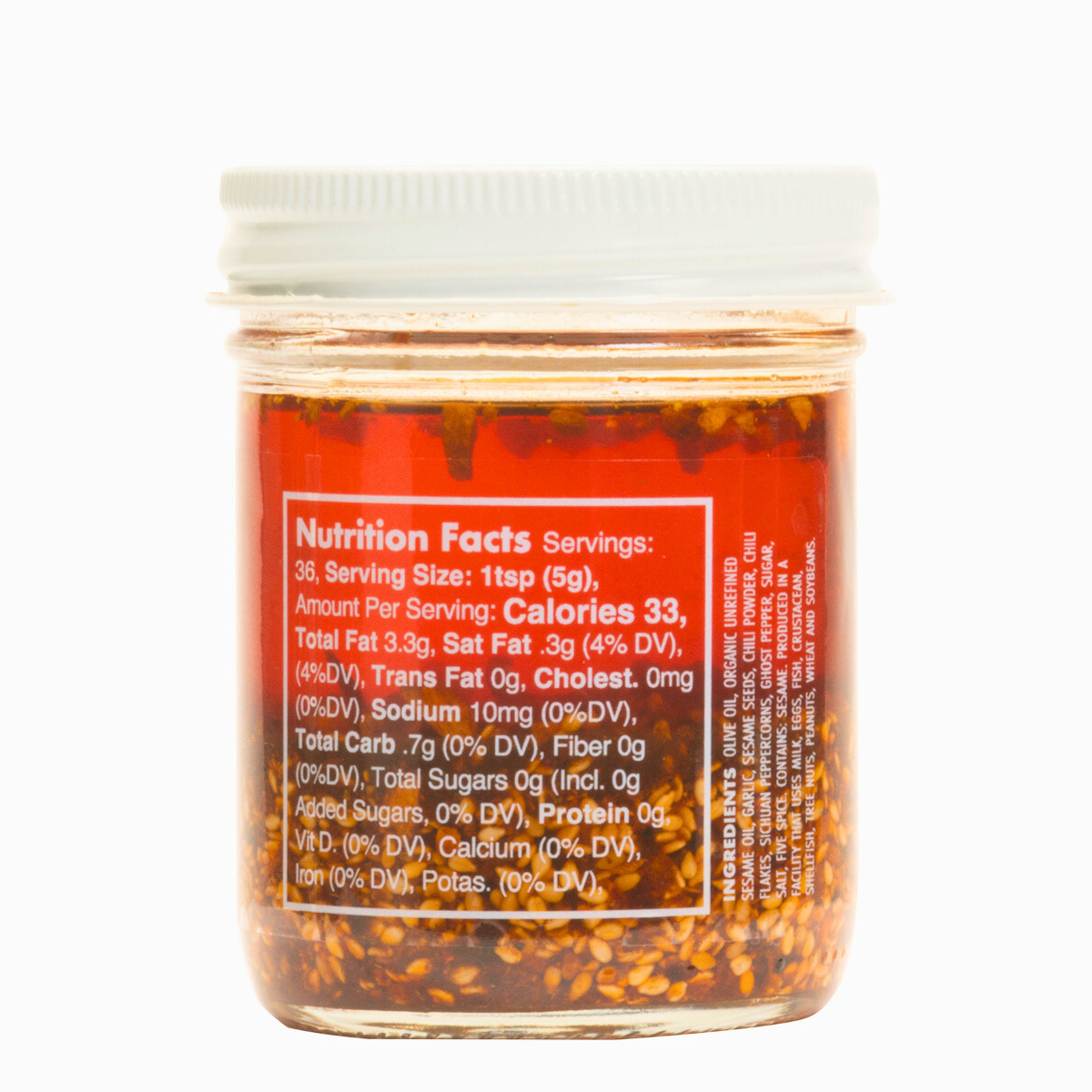 Nutrition facts & clean-label ingredients on a Ruby Crunch olive oil chili crisp condiment jar, showing the ruby hued oil & crispy bits. 