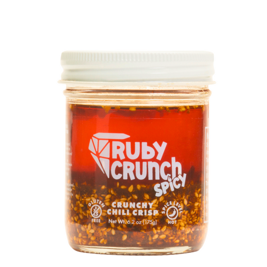 Front of Ruby Crunch spicy chili crisp 8oz jar showing contents of red oil and crunchy bits